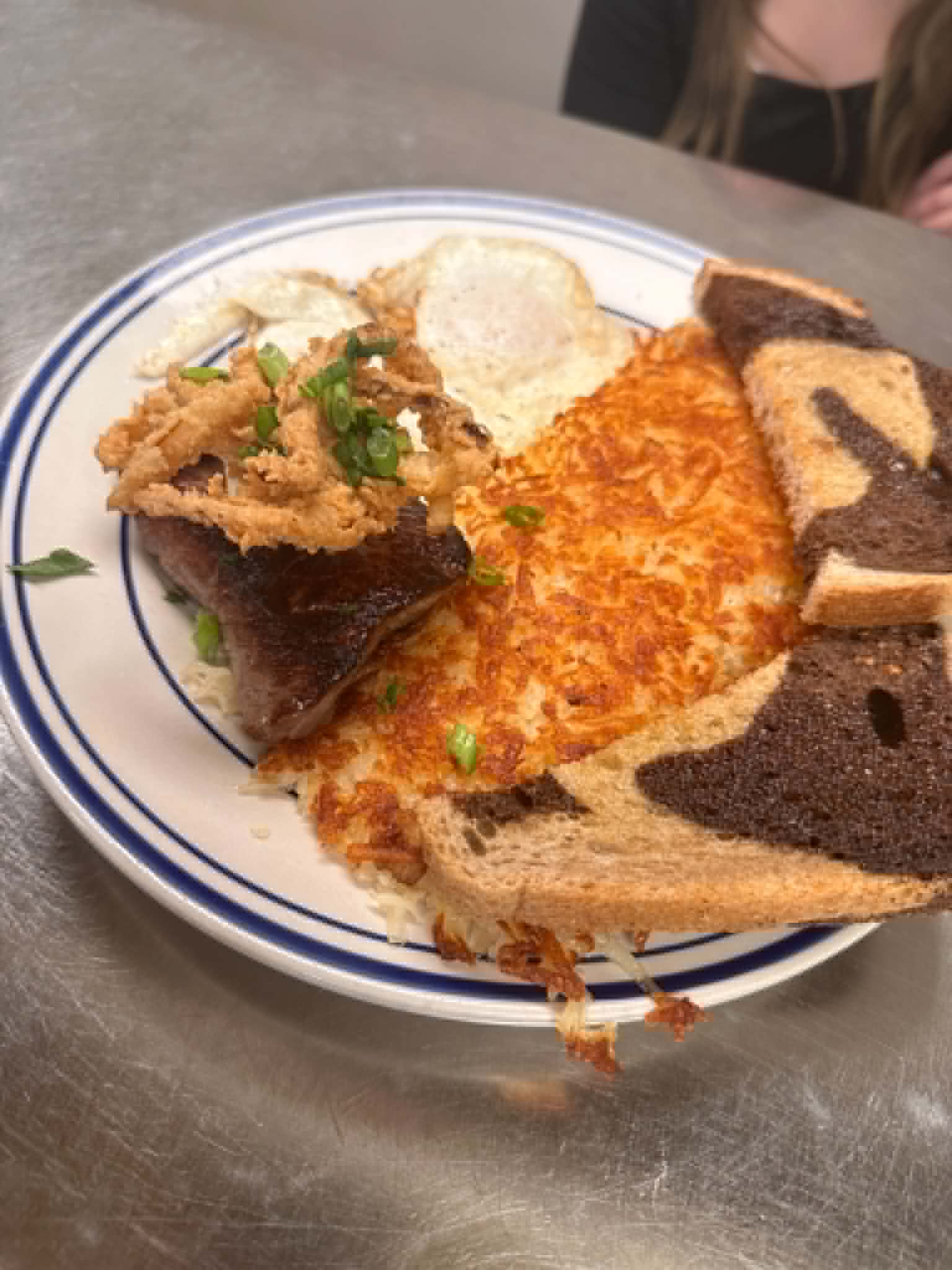 Breakfast plate with eggs, hash browns and toast