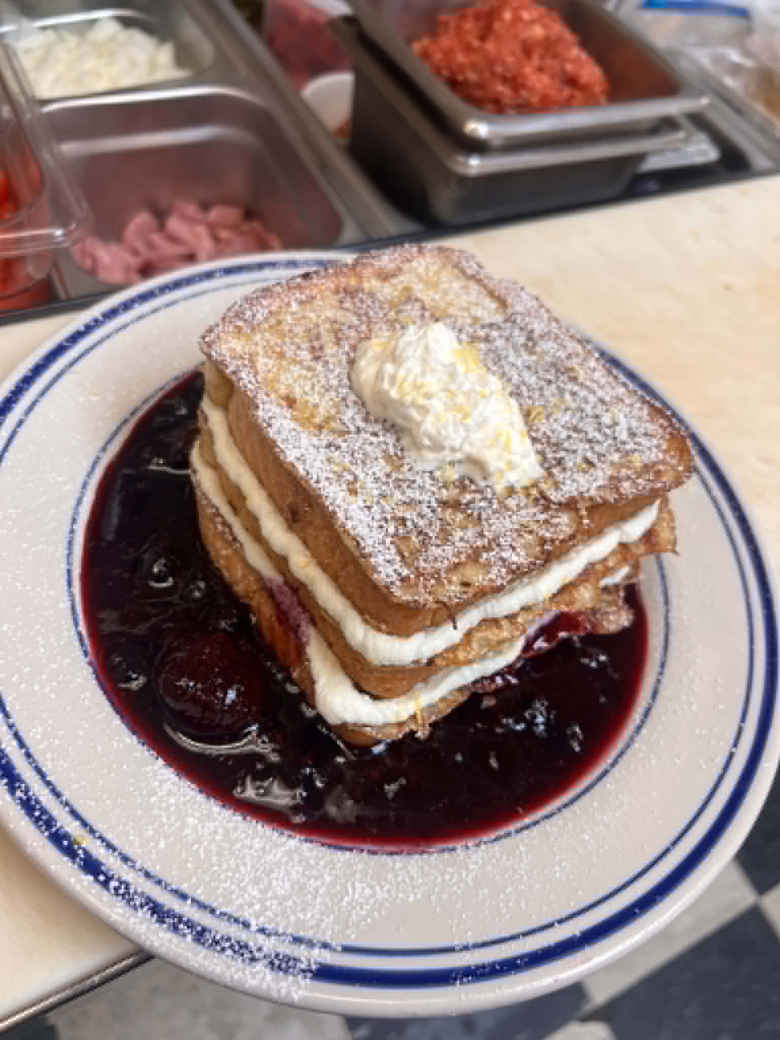 Stuffed French toast with berry compote and whipped cream